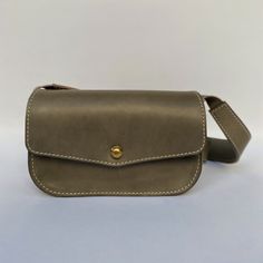 Just like the name claims - a mini version of the newest member of our family. The Mini Field Bag is for the true minimalist. Ready for any adventure, the Mini Field Bag features a brass pull release closure, a nice zipper under the front flap, and a large back pocket and an interior card holder pocket. Dimensions 5" H x 8" W x 2.5" D Strap length 41” adjustable to 43” All our bags are made with American sourced fully vegetable tanned leather. When exposed to sunlight, oils and water, the leathe Field Bag, Brass Pulls, Autumn Sales, Wallet Accessories, Vegetable Tanned Leather, Card Holder, Brass, Wallet, Shoulder Bag