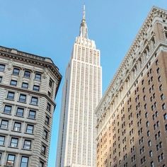 the empire building towering over other buildings in new york city