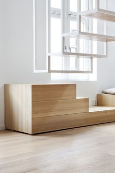 an empty room with stairs leading up to the bed and another set of steps on the floor