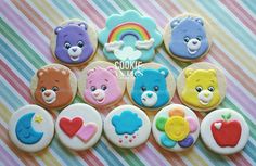 there are many decorated cookies with bears on them and rainbows in the back ground