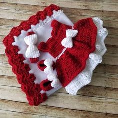 a crocheted hat and diaper set on a wooden surface