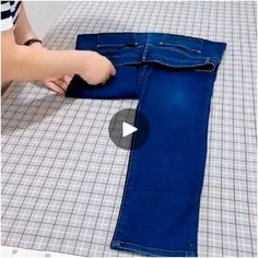 someone is making a pair of blue jeans