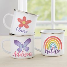 three personalized coffee mugs sitting on top of a table