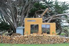 a small house made out of wood stacked on top of a pile of firewood