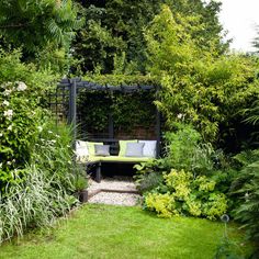 an outdoor seating area surrounded by greenery