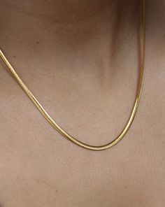 This 18K gold plated SLINKY ESSENTIAL CHAIN is the perfect addition to your everyday wardrobe. Made of high-quality stainless steel, this chain is durable and versatile, making it suitable just any occasion. It's an essential piece that will layer perfectly with any other chain or pendant necklace . Classic Gold Snake Chain Necklace, Classic Gold Herringbone Necklace With Snake Chain, Classic Yellow Gold Snake Chain Necklace, Classic Gold Link Herringbone Necklace, Gold Classic Herringbone Link Necklace, Dainty Gold Snake Chain Necklace, Everyday Yellow Gold Adjustable Snake Chain Necklace, Tarnish Resistant Gold Plated Snake Chain Necklace, Yellow Gold Delicate Snake Chain Necklace For Everyday