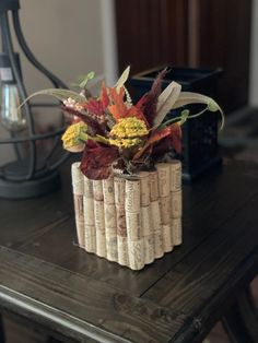 an arrangement of flowers and wine corks on a table