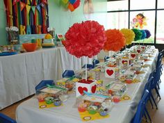 a table set up with pom poms by simply nesting for a party