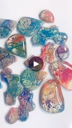 a group of glass hearts sitting on top of a white table next to each other