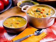 two bowls of soup are sitting on a table