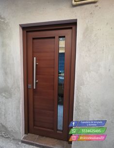 a wooden door is shown in front of a wall with a glass paneled window