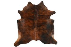 a brown and black cowhide rug on a white background