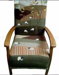 an upholstered chair with sheep and trees on it