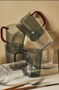 several glass cups are stacked on top of each other