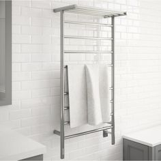 a towel rack in a bathroom with white tiles