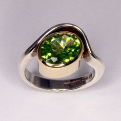 A very bright and pretty ring for you will dote on.  Gorgeous even green peridot sparkles in this sterling silver sea wave setting.   This piece can be made in a variety of metals including hand forged white, yellow, and rose gold as well as sterling silver. If you would like a quote for any of these materials please contact me. To see this ring style set with a pink tourmaline: https://www.etsy.com/ca/listing/169483988/pink-tourmaline-organic-sterling-silver This piece is ready to ship in size 7 1/2, or can be custom made to your size in 4-6 weeks.  Metals All gold, platinum, and silver used in my work is custom formulated and forged in my Waterton Studio.  Metals are first cast in a custom made ingot, then hammered and drawn before they are ready for working.  Producing my own gold allow Anniversary Jewelry With Polished Tsavorite, Tsavorite Rings With Polished Finish For Anniversary, Anniversary Tsavorite Rings With Polished Finish, Round Peridot Jewelry With Polished Finish, Modern Sterling Silver Green Rings, Green Peridot Jewelry With Polished Finish, Modern Peridot Rings For Anniversary, Formal Rings With Polished Peridot, Polished Peridot Jewelry