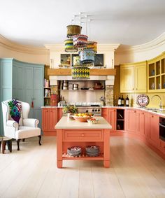 a kitchen with an island in the middle and lots of cupboards on it's sides