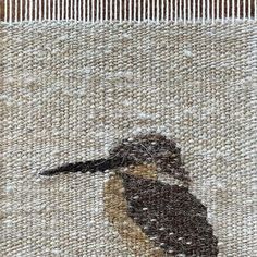 a close up of a piece of fabric with a bird on it