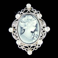 "PERFECT CHRISTMAS GIFT FOR LADIES!! This Classy BLACK Cameo Brooch with Swarovski crystals measures 1 3/8\" wide X 1 3/4\" high (35mm X 44mm). Crystal Color: Crystal Clear It goes well with modern as well as vintage styling...it really depends how you want to wear it. Great piece for your collection! Prices are in US$. For shipping policies and other important information, click on \"profile\" on the right. See an item that you like but has already been sold? Contact me to see if I have more! T White Cameo Brooch For Wedding, White Cameo Brooches For Wedding, White Cameo Wedding Brooches, Classic Black Brooches For Wedding, Classic Black Wedding Brooch, Classic Black Wedding Brooches, White Rhinestone Anniversary Brooches, Elegant Black Anniversary Brooch, White Crystal Brooch For Anniversary