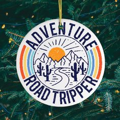 an ornament hanging from a christmas tree with the words adventure roadtripper on it