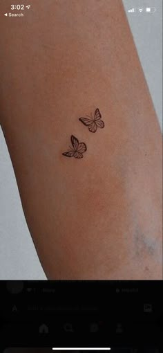 two butterflies tattoo on the left side of the right arm, and one is black