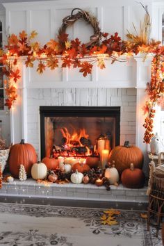 a fireplace decorated with fall leaves and candles