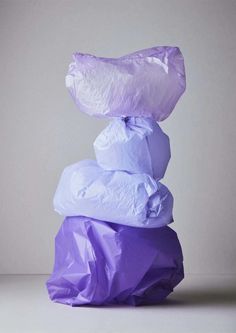 three bags stacked on top of each other, one purple and the other light blue