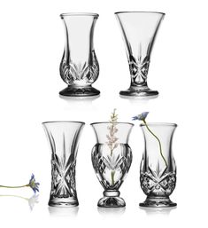 four glass vases with flowers in them on a white background and one is empty