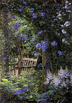 a wooden bench sitting in the middle of a lush green forest filled with pink flowers