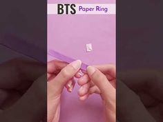 two hands holding a piece of paper with the word bts on it and an image of