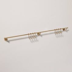 a metal rack with five hooks on it