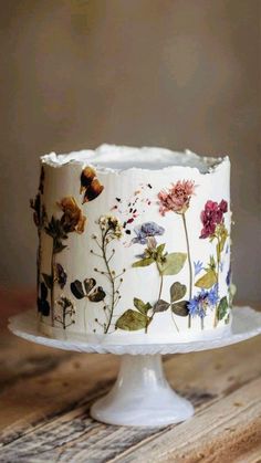 a white cake with flowers painted on it