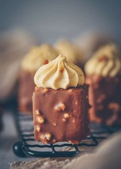 chocolate cake with white frosting and sprinkles on a wire cooling rack