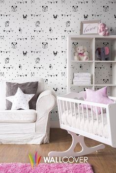 a baby's room with white furniture and wallpaper