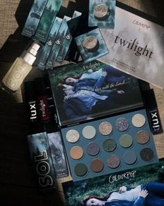 the contents of a twilight makeup collection laid out on a table