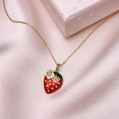 "Fruity, sweet, & juicy! Add a little sassy sweetness to everyday outfits with this adorable strawberry charm! Beautifully detailed with red enamel, sparkling little crystals and a cute little daisy. Wildflower + Co. Jewelry Personalize with (1) your choice of necklace, (2) option to add additional charms, & (3) choice of card for the box! Packaged in a super cute gift box. ♥ Choose your necklace! See photo + drop-down + descriptions below. ♥ Add more charms to make this even more specia Cute Enamel Necklaces For Gifts, Cute Red Charm Necklace For Gift, Cute Red Charm Necklaces For Gifts, Trendy Strawberry Print Jewelry Gift, Trendy Strawberry Print Jewelry As Gift, Sweet Strawberry Print Jewelry As Gift, Photo Drop, Strawberry Charm, Cute Gift Boxes