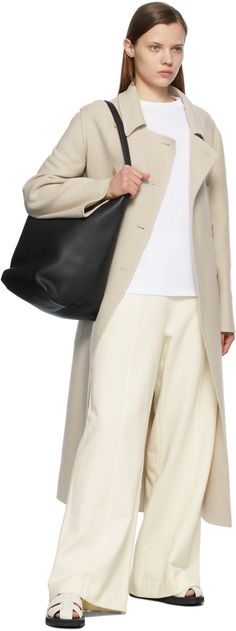 Long sleeve brushed cashmere and virgin wool-blend coat in beige. Spread collar. Double-breasted button closure at front. Flap pockets at waist. Central vent at back hem. Unlined. Tonal hardware. Supplier color: Parchment 90s Bag, Wool Blend Coat, Knit Crewneck, Accessories For Women, Long Coat, Luxury Streetwear, Sleeve Cotton, The Row, Double Breasted