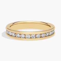 a yellow gold wedding band with white diamonds