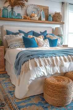 a bed with blue and white pillows on top of it