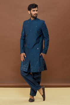 Blue sherwani with mirror work and mandarin collar. Paired with pant.
Components: 2
Pattern: Embroidered
Type Of Work: Mirror
Neckline: Mandarin
Sleeve Type: Full
Fabric: Dola Silk
Color: Blue
Other Details: 
Mirror work
Occasion: Sangeet - Aza Fashions Designer Sherwani With Zari Work For Navratri, Designer Zari Work Sherwani For Navratri, Bollywood Style Semi-stitched Sherwani With Mirror Work, Navratri Designer Sherwani With Zari Work, Designer Sherwani With Dabka Work For Navratri, Formal Kurta With Mirror Work For Diwali, Formal Mirror Work Kurta For Diwali, Formal Blue Anarkali Set For Diwali, Formal Sets With Mirror Work For Navratri