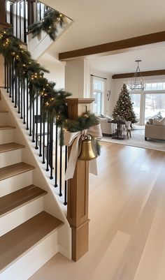 a staircase decorated for christmas with lights and garland on the bannister railings