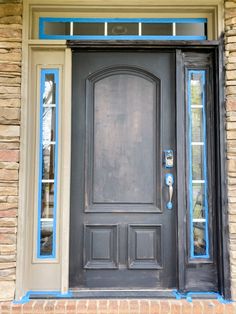 the front door is painted black and has blue trim