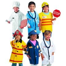 children dressed up in costumes standing next to each other and posing for the camera with one holding a stop sign