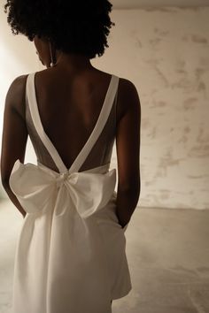 the back of a woman's dress with a large bow on it