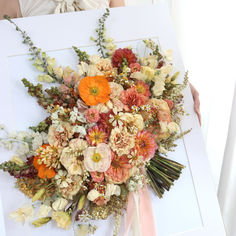 a bouquet of flowers sitting on top of a white table