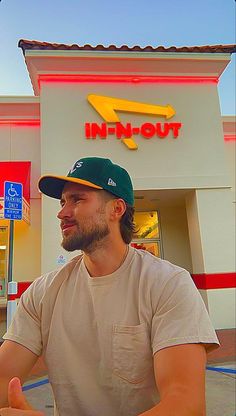 a man sitting in front of a fast food restaurant