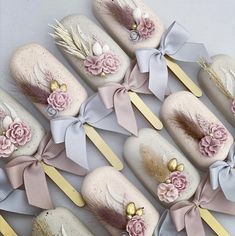 there are many pink and gold decorated toothbrushes with flowers on them next to each other