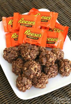 chocolate peanut butter energy bites on a white plate with orange candy bars in the background