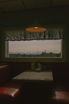 a table and some chairs in front of a window