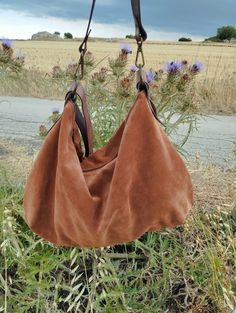 Soft suede hobo bag made of soft tobacco-colored Italian suede. This bag is so comfortable and practical thanks to the metal zip closure and its soft structure. You will be amazed at the amount of things it can contain Features : - tobaco suede, - Tobaco hand dyed leather strap, - Zipped bag, - Unlined, - Inside cotton zipped pocket, - Leaf-shaped leather label. Size: - Height 12 inch, - Lenght (opening of the zip)14 inch, - Length max 17 inch, - Depth 3 inch, - Shoulder belt is adjustable 24/47 Suede Hobo Bag For Everyday Use, Suede Hobo Bag For Daily Use, Shoulder Belt, Hobo Bags, Leather Label, Zipped Bag, Hobo Handbags, Leather Tassel, Perfect Bag